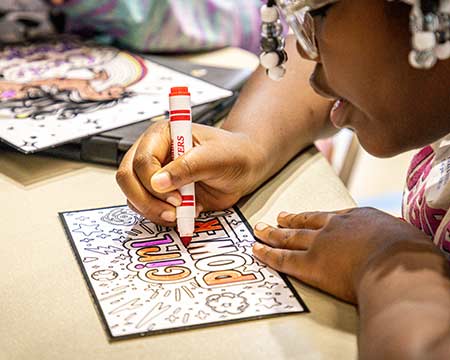 a young girl with markers